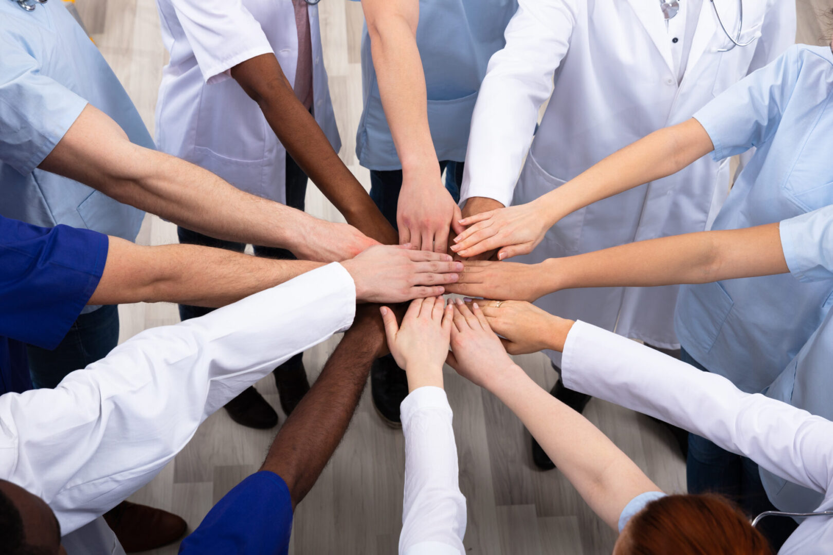 Elevated View Of Doctors Stacking Hands