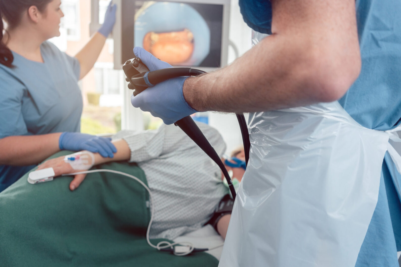 Doctor during endoscopy checking picture of mouth on screen